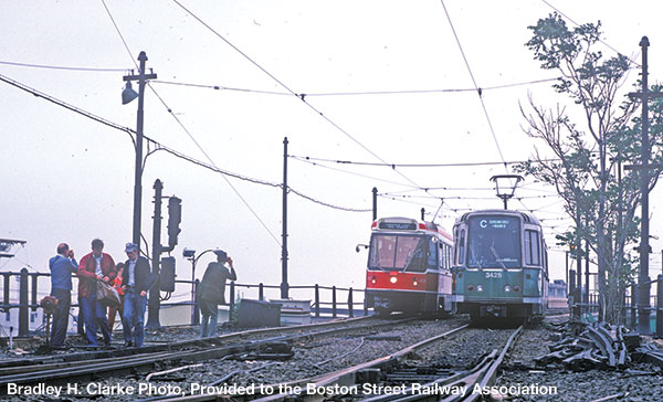Fans shoot a posed "meet" of a Canadian Light Rail Vehicle on a fan trip (while the car was visiting Boston from Toronto) and an MBTA LRV, headed for Boston, on the Lechmere Viaduct in Cambridge. Bradley H. Clarke Photo.